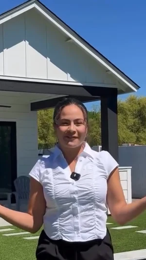 Agent presenting a new-build home and backyard
